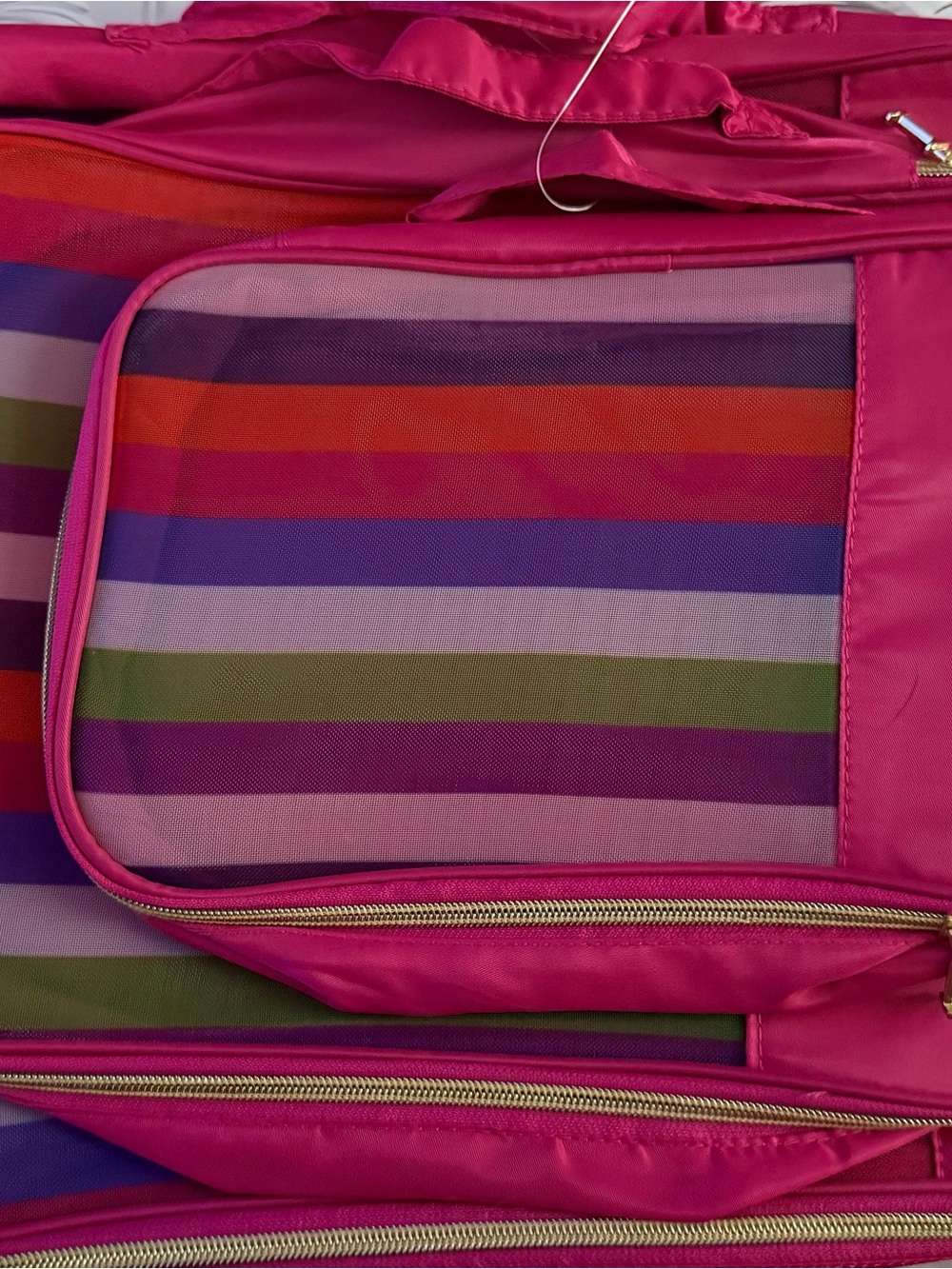 Isaac Mizrahi packing cubes with a pink and striped design.